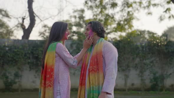 Cute romantic Indian couple doing romance at Holi alt