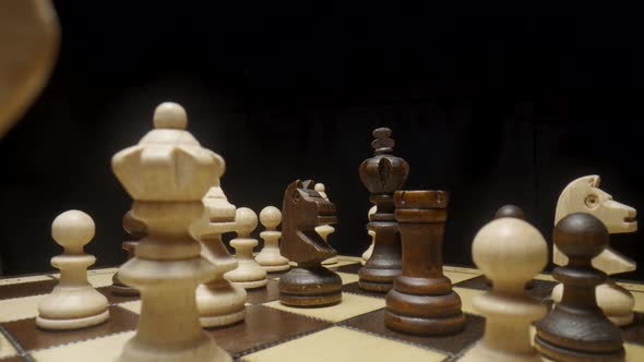 Camera Pans Over Chessboard with Chess Pieces Placed and Focuses on Brown Horse alt