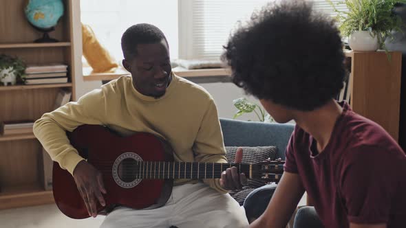 Black Man Teaching Playing Guitar, Stock Footage | VideoHive