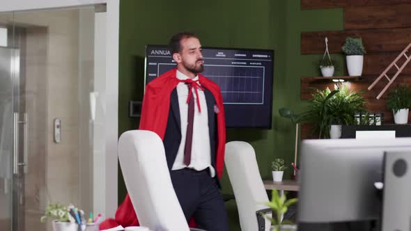 Slow Motion Shot of Businessman Wearing a Red Cape Walking Silly in the Office alt