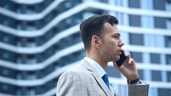 Young Trader Man Talking On Mobile Phone.