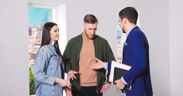 Close Up of Handsome Happy Caucasian Man Real Estate Realtor Giving Keys for New Apartment alt