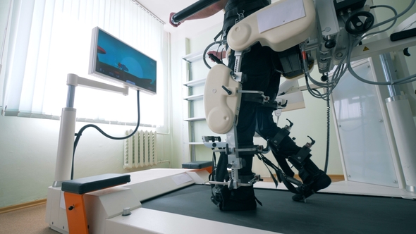 Modern Medical Recovery Device. Disabled Man Is Training To Walk with ...