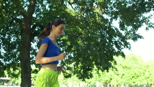 Beautiful Fitness Woman Jogging in Summer Park alt
