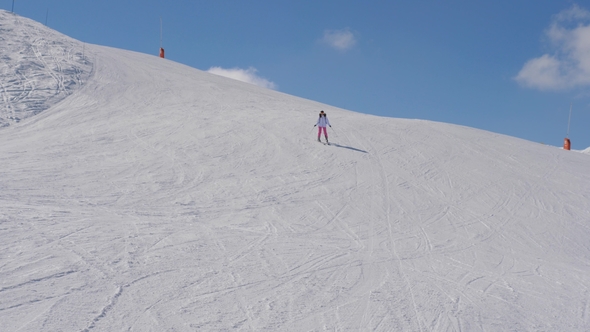 Beginning And Insecure Woman Skier Skiing Down The Mountain Slope