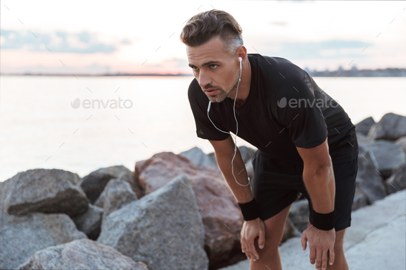 Portrait of a exhausted sportsman Stock Photo by vadymvdrobot | PhotoDune