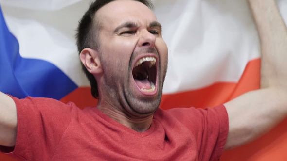 Czech Fan Celebrating While Holding the Flag of Czech Republic alt