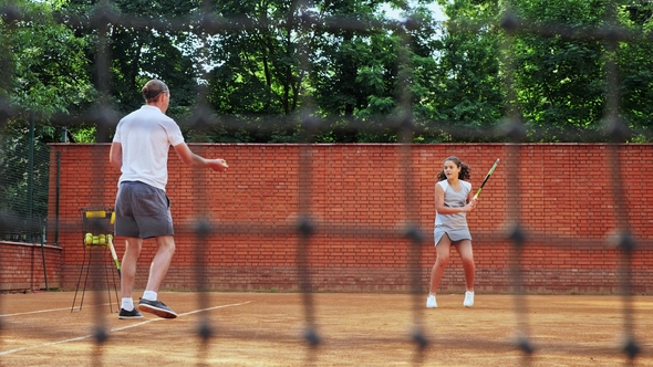 Coacher Teaching Young Girl To Playing Tennis. alt