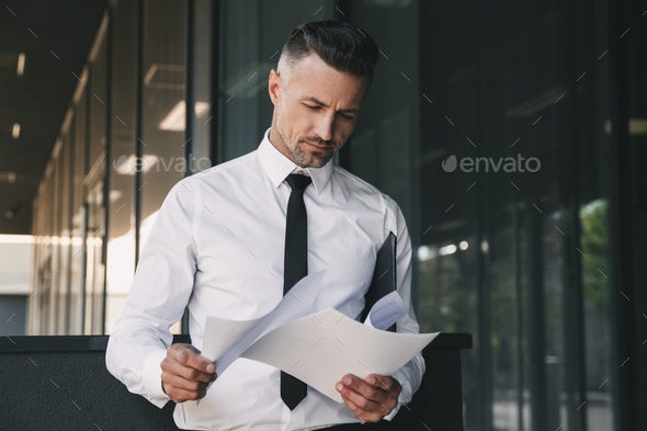 Portrait of a focused young businessman Stock Photo by vadymvdrobot