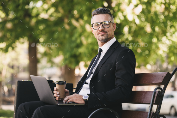 Portrait of a happy businessman dressed in formal clothes Stock Photo by vadymvdrobot