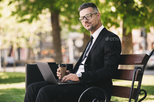 Portrait of a smiling businessman dressed in formal clothes Stock Photo by vadymvdrobot