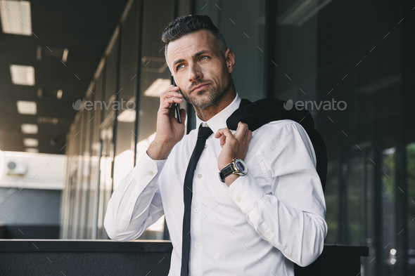 Portrait of a handsome young businessman Stock Photo by vadymvdrobot