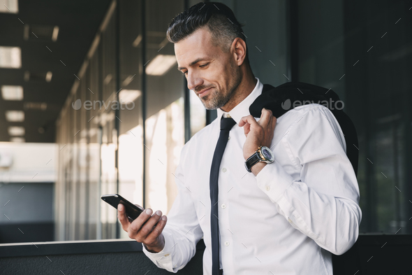 Portrait of a smiling young businessman Stock Photo by vadymvdrobot