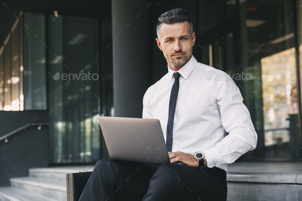 Portrait of a successful young businessman Stock Photo by vadymvdrobot
