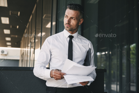 Portrait of a pensive young businessman Stock Photo by vadymvdrobot