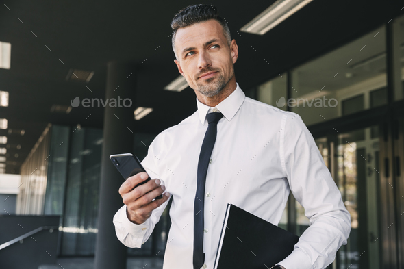 Portrait of a pensive young businessman Stock Photo by vadymvdrobot