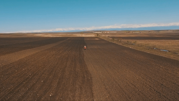 Agricultural Tractor Cultivating Field