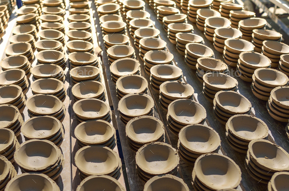 Ceramic cup in rack prepare for bring in furnace in factory Stock Photo by sommai