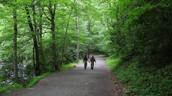Two Fisherman Are Walking in the Forest After Fishing alt