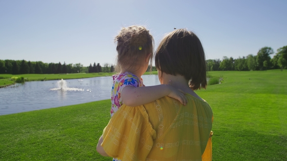Mom and Special Need Daughter Walking on Meadow alt