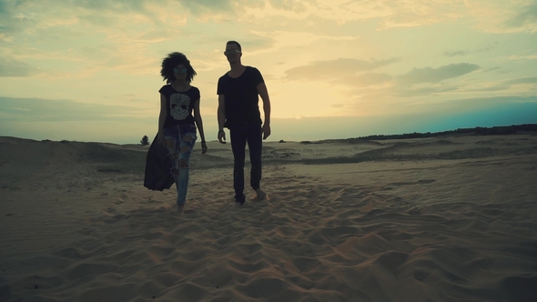 Couple Walking in Desert at Sunset