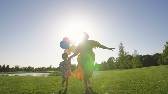 Mom and Special Needs Girl Running with Baloons alt