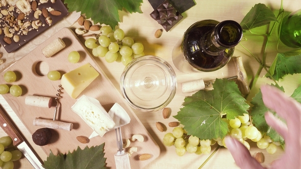 A Glass and a Bottle of Wine and a Snack Top View