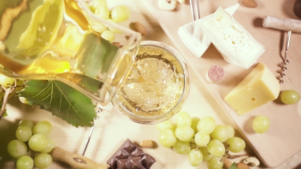 A Glass and a Bottle of Wine and a Snack Top View