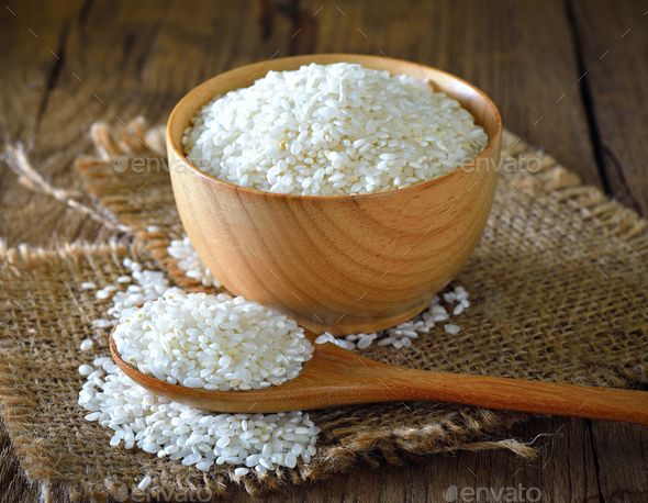 rice in bowl on wooden surface Stock Photo by sommai | PhotoDune