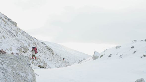 Porters with Heavy Load on the Larke Pass in Nepal, 5100m Altitude alt