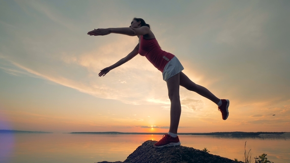 A Girl Puts Up Her Arms and One Leg alt