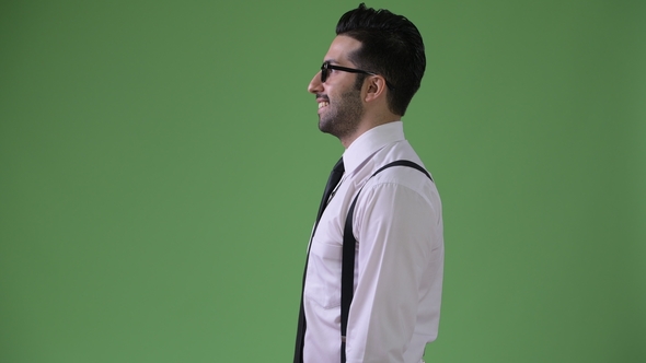 Young Handsome Bearded Persian Businessman Against Green Background alt