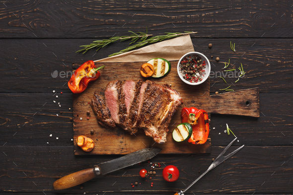 Grilled meat and vegetables on rustic wooden table Stock Photo by Prostock-studio