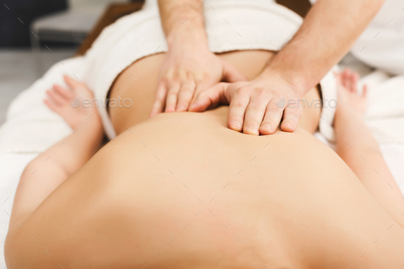 Closeup of hands massaging female shoulders and back Stock Photo by Prostock-studio