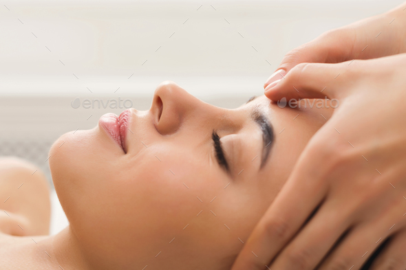 Woman Getting Professional Facial Massage At Beauty Salon - 