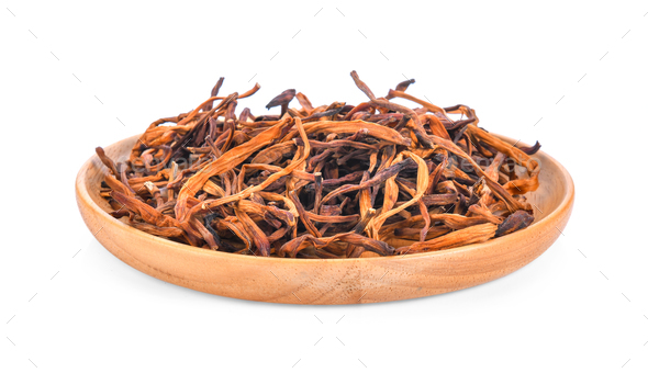 dried day lily flower in wood plate isolated on white background