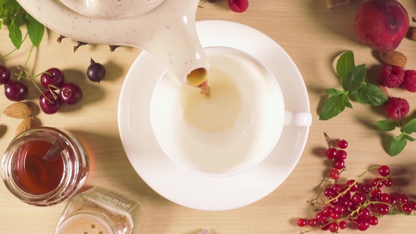 Tea Is Poured Into a White Cup