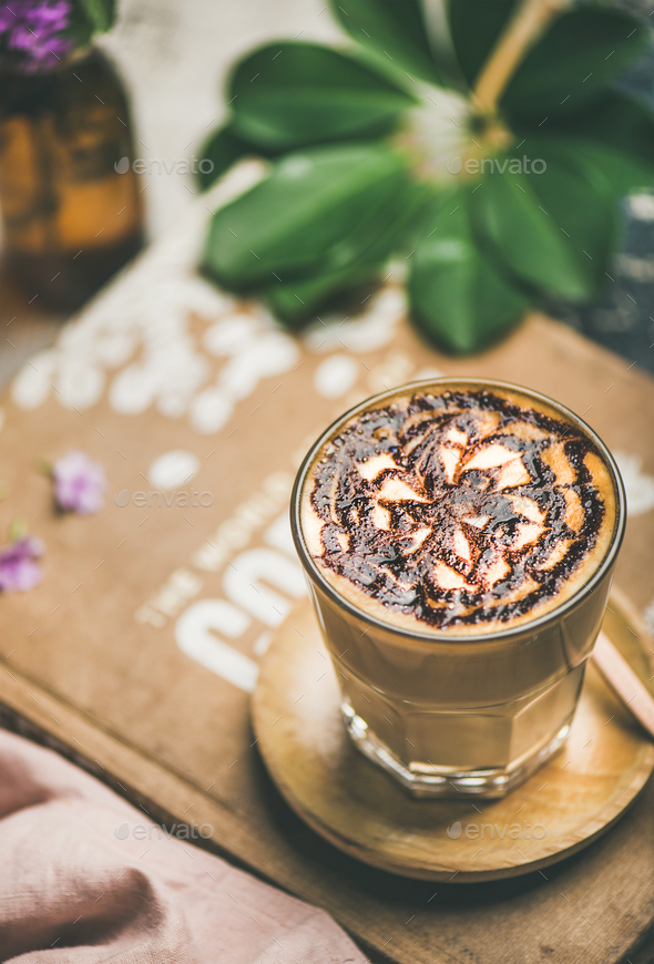 Classic Latte coffee with chocolate sauce pattern in tall glass Stock Photo by sonyakamoz
