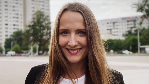Portrait of Beautiful Caucasian Girl Smiling on Summer Day in City