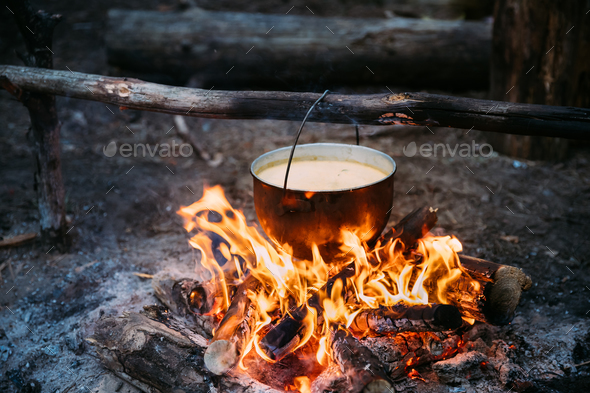 Old Camp Saucepan Boiled Water For Soup Preparation On A Fire In Stock Photo by Grigory_bruev