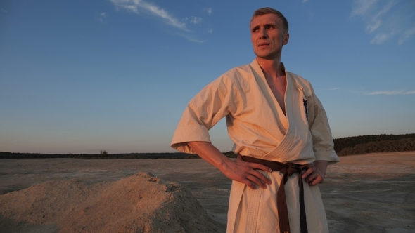 An Athlete Looks at the Sunset After a Hard Karate Training Session alt