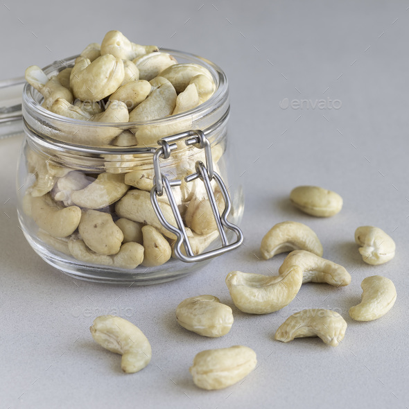 Download Cashew Nuts In Glass Jar On A Light Gray Concrete Background Sq Stock Photo By Iuliia N