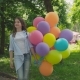 Portrait of Happy Girl Poses and Turns Around at Camera with Balloons in Park - VideoHive Item for Sale