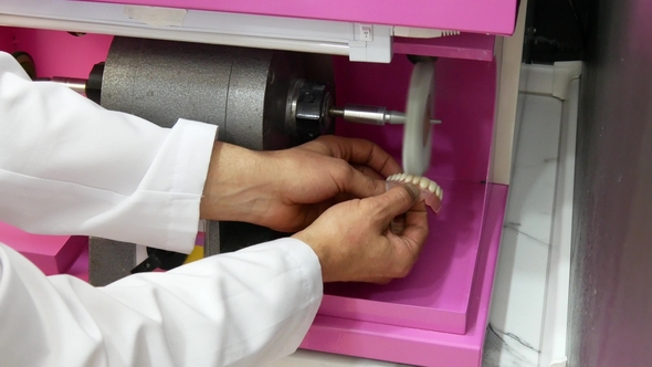 Dental Technician Polishing a Dental Prosthesis