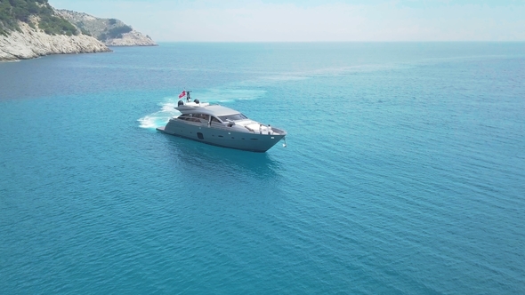 Amazing View To Yacht Sailing in Sea. Stock. Sunset View of the Yacht. Luxury Vacation on a Yacht alt