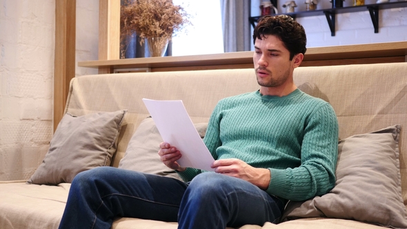 Upset Man Disappointed While Reading Documents, Paperwork alt