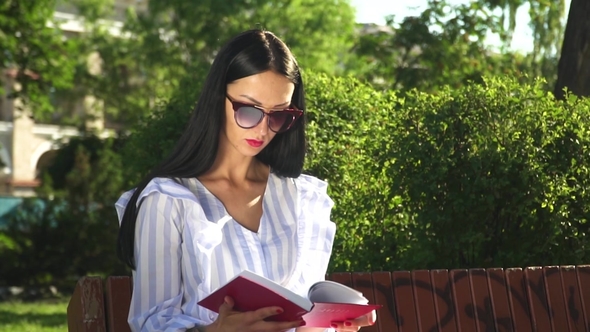 Gorgeous Brunette Finished of Reading Book in the Park alt