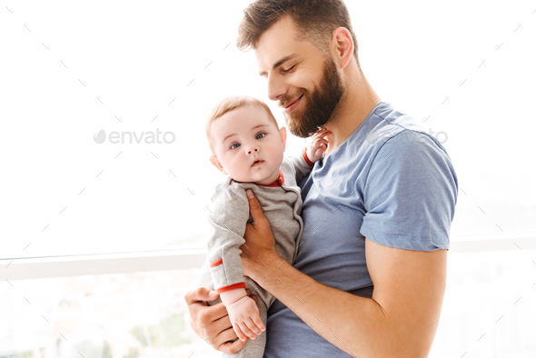 Happy young man father dad other holding in hands his little child ...