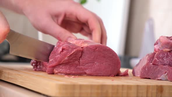 Man Cuts Meat with Knife on Wooden Board Preparation Minced Beef Pork for Cutlets Meatballs Chops