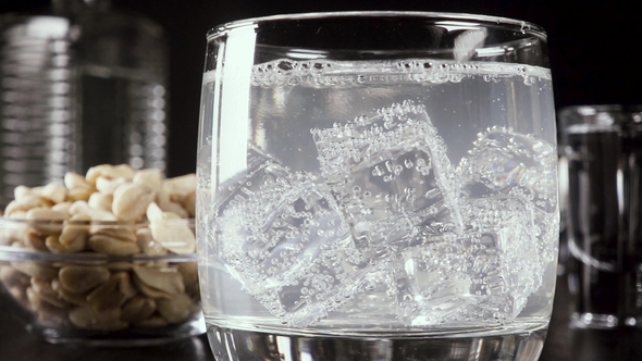 a Glass of Vodka on the Table with a Snack